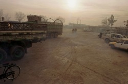 Kabul, Afghanistan -- Trucks wait in line at the warehouse prior to WFP food distribution at the old Soviet compund in Kabul. 12/20/01 (Photo by Bikem Ekberzade)